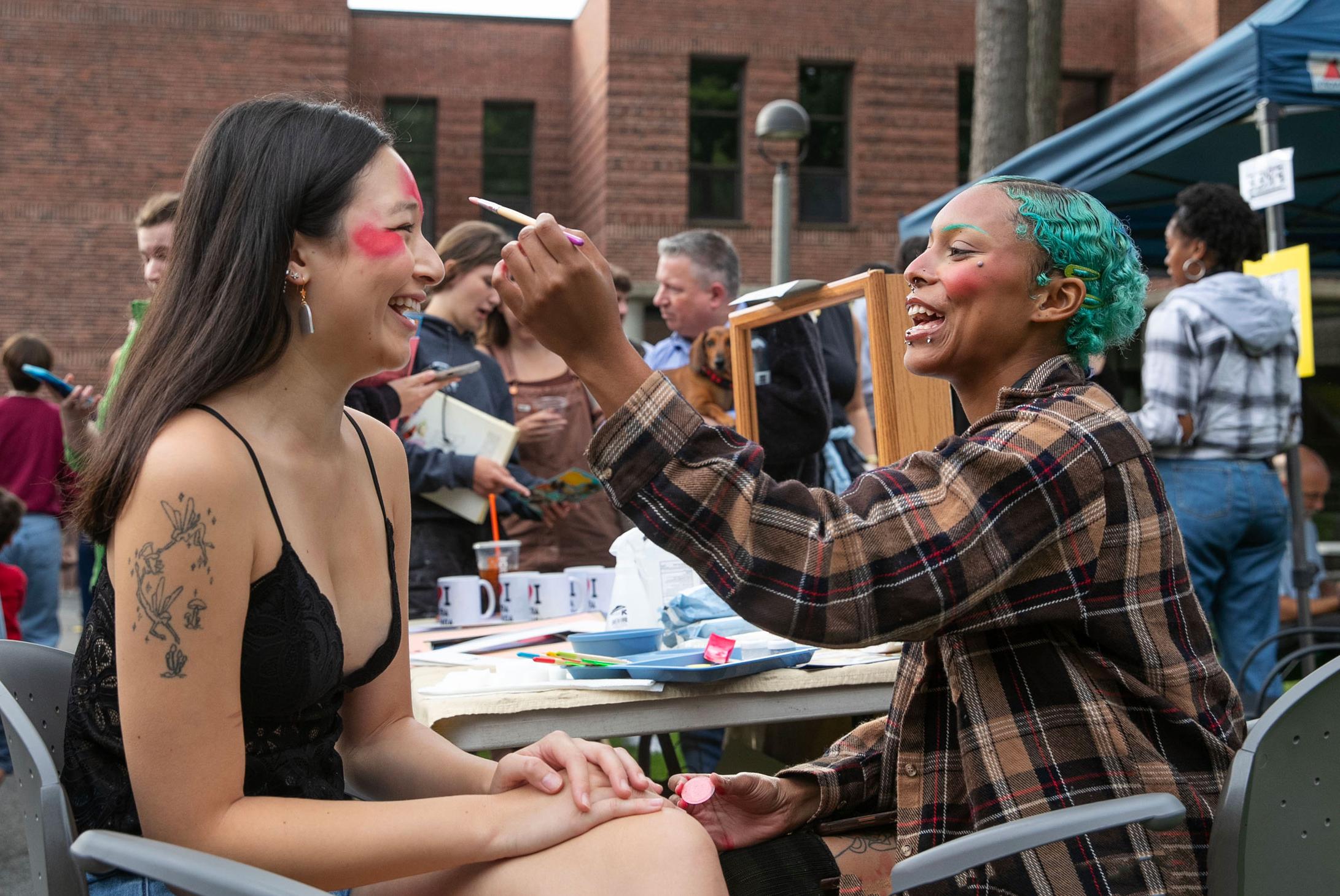 two students at a college arts fair 